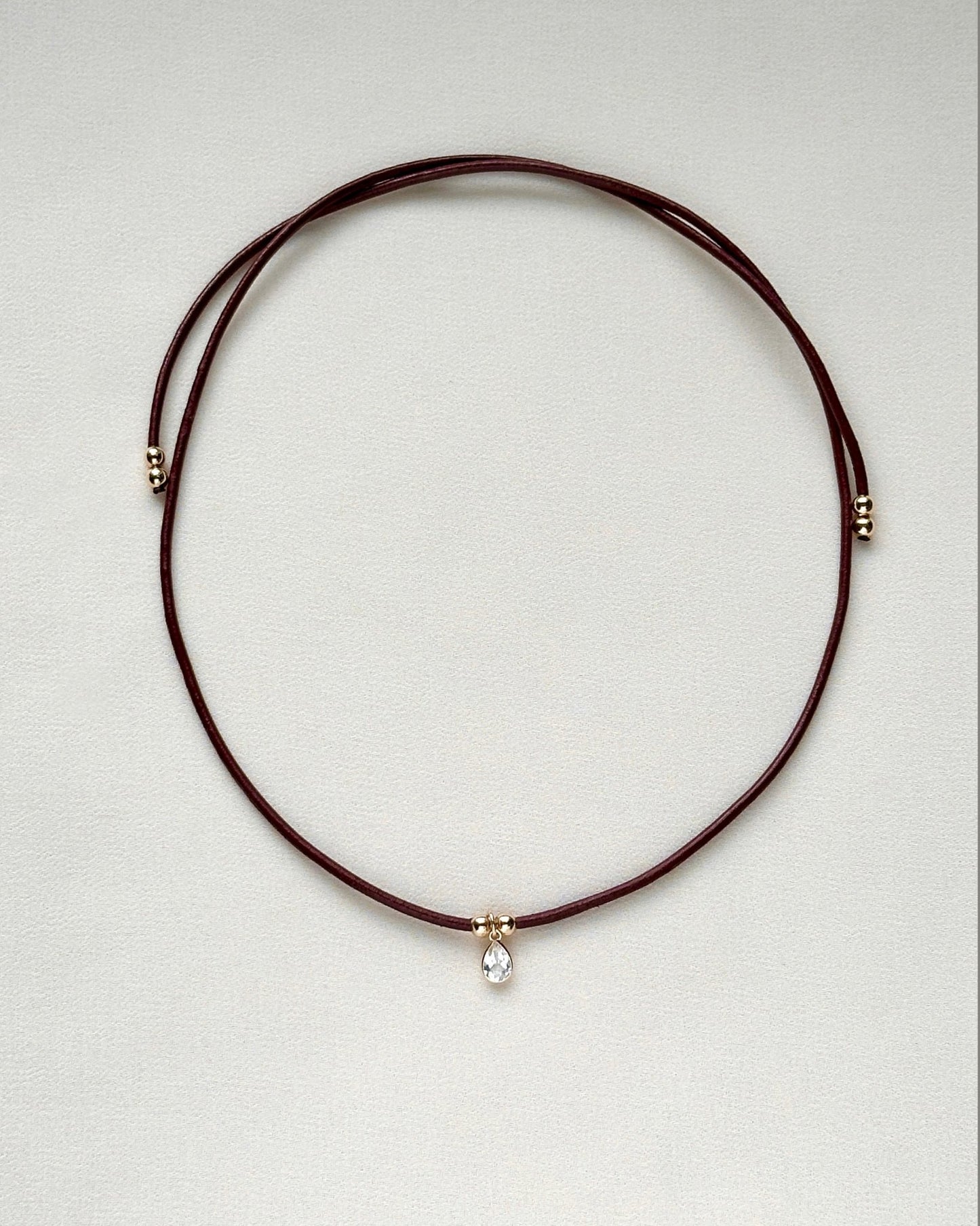 burgundy leather cord gemstone necklace laid flat — emma necklace