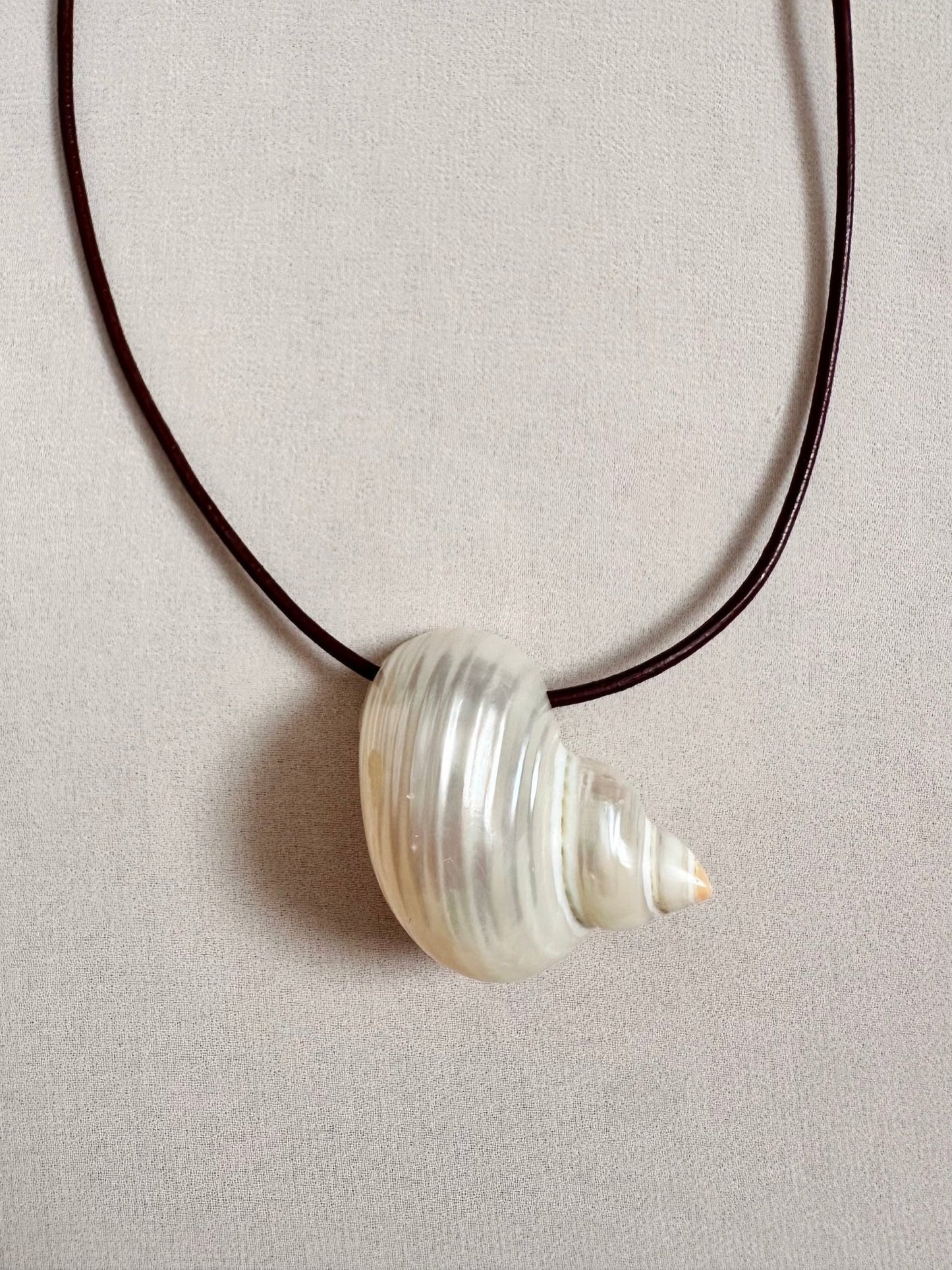 Large natural shell pendant on burgundy leather cord