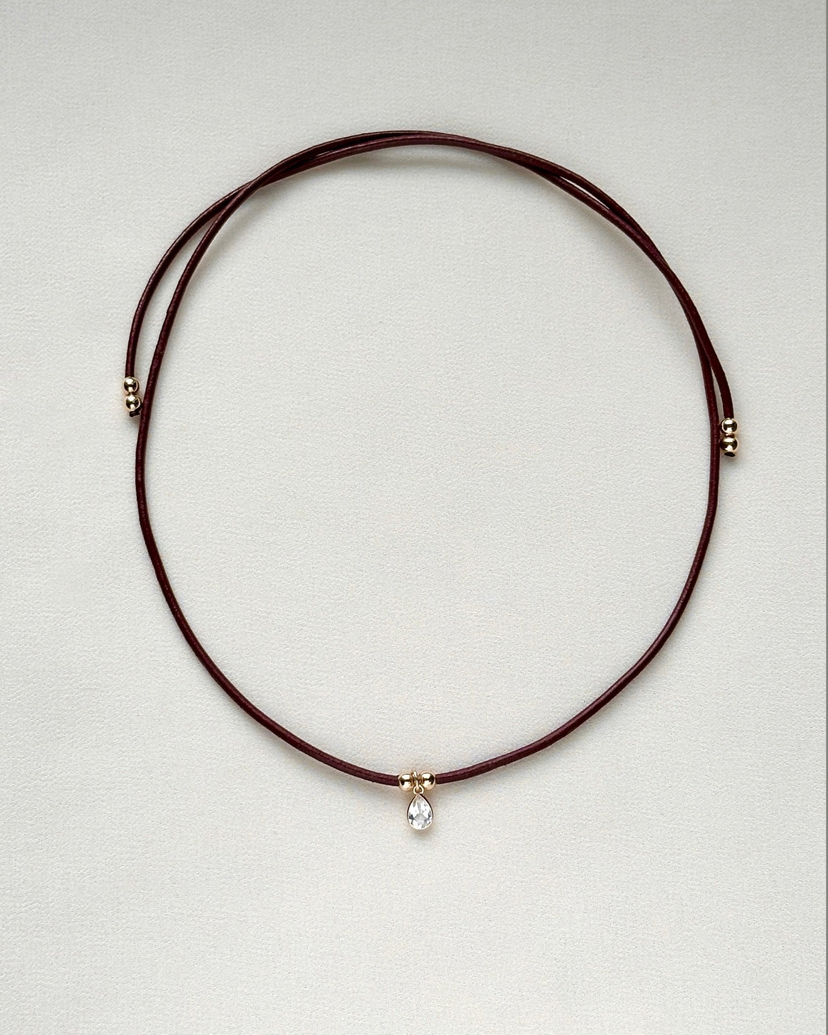 burgundy leather cord gemstone necklace laid flat — emma necklace