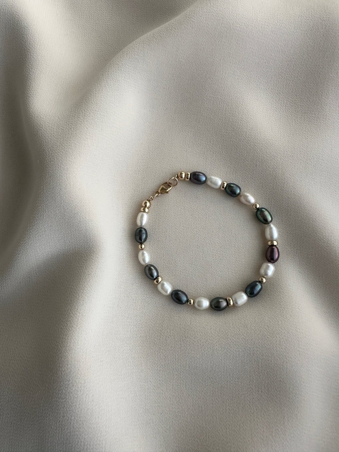 Pearl bracelet on a soft fabric background