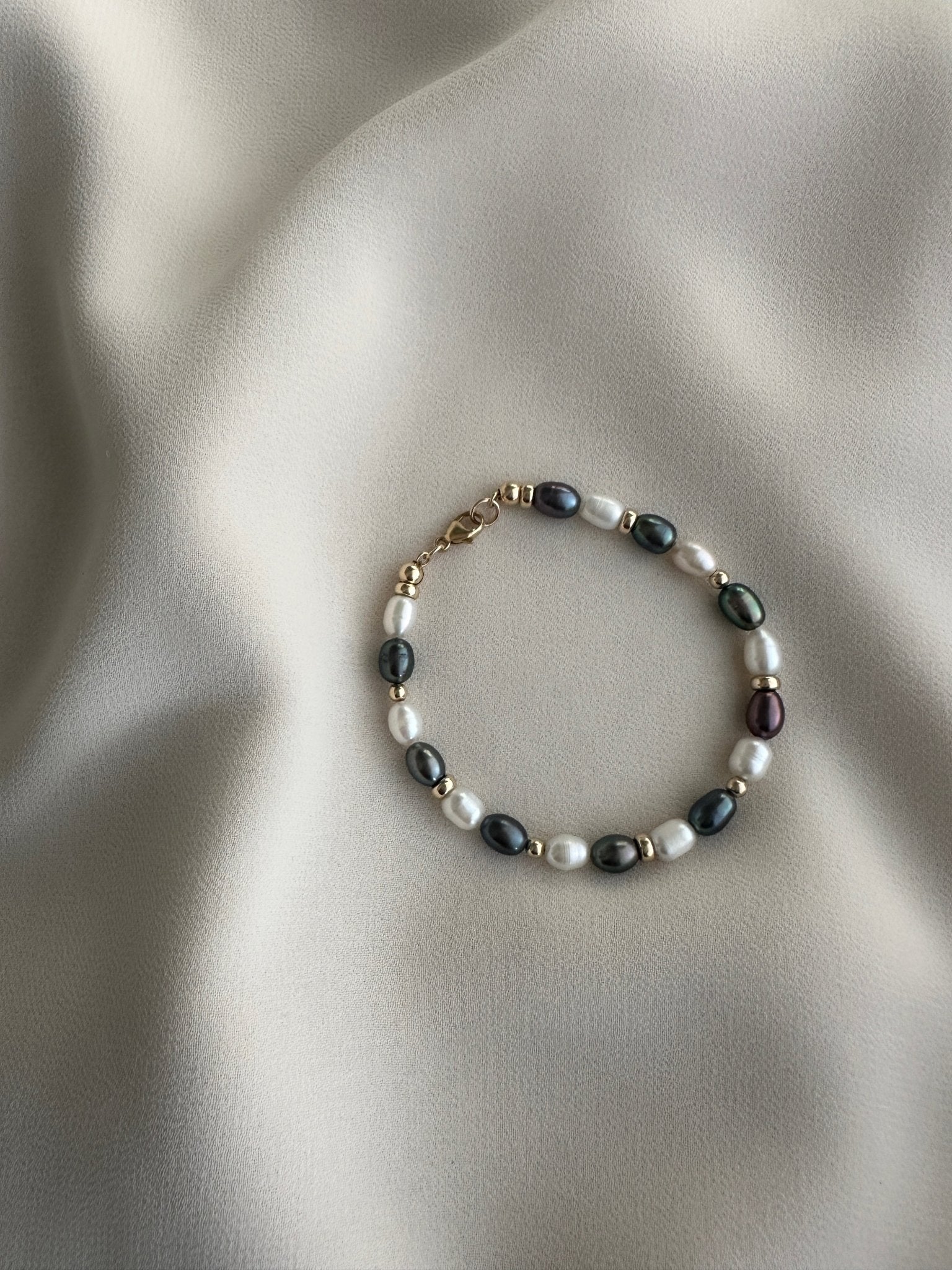 Pearl bracelet on a soft fabric background