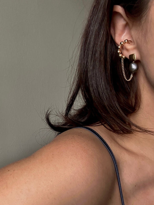 NOAH pearl stud earrings worn on ear